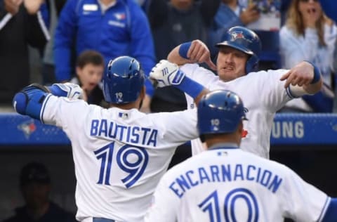 Sep 24, 2016; Toronto, Ontario, CAN: Toronto Blue Jays right fielder Jose Bautista (19) bumps forearms with third baseman Josh Donaldson (20) after scoring them both and first baseman Edwin Encarnacion (10) with a three run home run against New York Yankees in the eighth inning at Rogers Centre. Mandatory Credit: Dan Hamilton-USA TODAY Sport