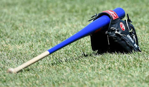 Apr 16, 2016; Boston, MA, USA; The glove and bat of Toronto Blue Jays first base coach Tim Leiper (34) rests on the grass prior to a game against the Boston Red Sox at Fenway Park. Mandatory Credit: Bob DeChiara-USA TODAY Sports