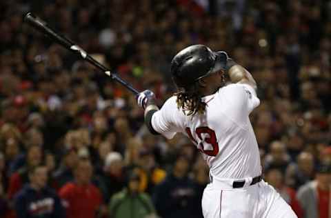 Oct 10, 2016; Boston, MA, USA; Boston Red Sox first baseman Hanley Ramirez (13) connects for a RBI single in the eighth inning against the Cleveland Indians during game three of the 2016 ALDS playoff baseball series at Fenway Park. Mandatory Credit: Greg M. Cooper-USA TODAY Sports