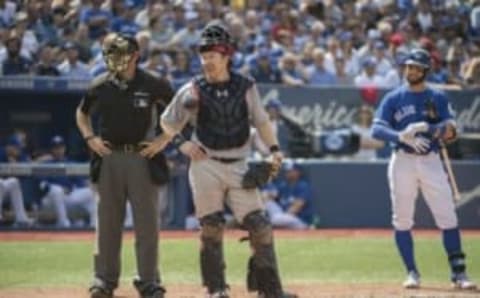 Sep 10, 2016; Toronto, Ontario, CAN; Home plate umpire James Hoye and Boston Red Sox catcher Ryan Hanigan (10) and Toronto Blue Jays center fielder Kevin Pillar (11) wait as a play is being reviewed at Rogers Centre. Mandatory Credit: Nick Turchiaro-USA TODAY Sports