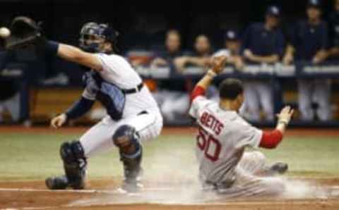 Sep 24, 2016; St. Petersburg, FL, USA;Boston Red Sox right fielder Mookie Betts (50) slides safe into home plate as Tampa Bay Rays catcher Curt Casali (19) attempted to tag him out at Tropicana Field. Mandatory Credit: Kim Klement-USA TODAY Sports