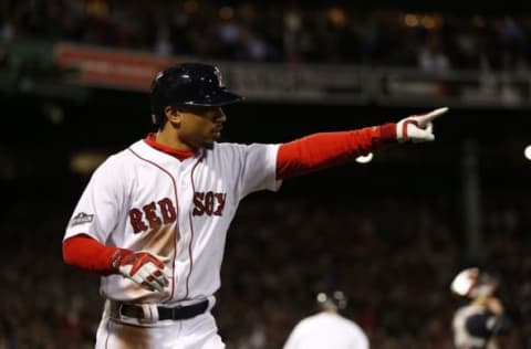 Oct 10, 2016; Boston, MA, USA; Boston Red Sox right fielder Mookie Betts (50) reacts after scoring a run in the eighth inning against the Cleveland Indians during game three of the 2016 ALDS playoff baseball series at Fenway Park. Mandatory Credit: Greg M. Cooper-USA TODAY Sports