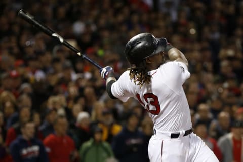 Oct 10, 2016; Boston, MA, USA; Boston Red Sox first baseman Hanley Ramirez (13) connects for a RBI single in the eighth inning against the Cleveland Indians during game three of the 2016 ALDS playoff baseball series at Fenway Park. Mandatory Credit: Greg M. Cooper-USA TODAY Sports