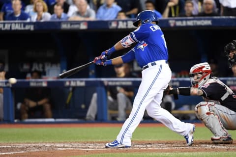 Oct 18, 2016; Toronto, Ontario, CAN; Toronto Blue Jays first baseman Edwin Encarnacion (10) hits an RBI single during the seventh inning against the Cleveland Indians in game four of the 2016 ALCS playoff baseball series at Rogers Centre. Mandatory Credit: Nick Turchiaro-USA TODAY Sports