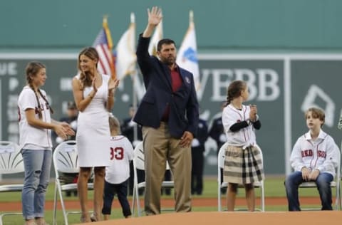 May 20, 2016; Boston, MA, USA; 2016 Red Sox Hall of Fame inductee Jason Varitek waves to the crowd before throwing out the first pitch with fellow inductees Larry Lucchino and Tim Wakefield (not pictured) before the start of the game against the Cleveland Indians at Fenway Park. Mandatory Credit: David Butler II-USA TODAY Sports