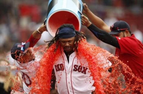 Aug 31, 2016; Boston, MA, USA; Boston Red Sox right fielder Mookie Betts (50) and pitcher Eduardo Rodriguez (52) dump powerade on first baseman Hanley Ramirez (13) after defeating the Tampa Bay Rays 8-6 at Fenway Park. Mandatory Credit: Greg M. Cooper-USA TODAY Sports