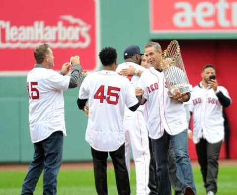 Oct 2, 2016; Boston, MA, USA; Boston Red Sox former pitcher Pedro Martinez (45) shakes the hand of another former teammate Mike Lowell as part of pregame ceremonies for designated hitter David Ortiz (34) before a game against the Toronto Blue Jays at Fenway Park. Mandatory Credit: Bob DeChiara-USA TODAY Sports