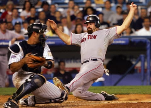 NEW YORK – JULY 03: Kevin Youkilis #20 of the Boston Red Sox scores a run in the eighth inning past Jorge Posada #20 of the New York Yankees on July 3, 2008 at Yankee Stadium in the Bronx borough of New York City. (Photo by Jim McIsaac/Getty Images)