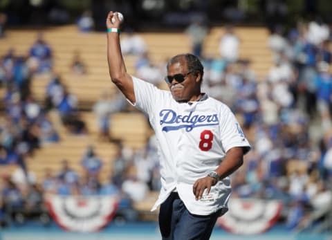 LOS ANGELES, CA – OCTOBER 17: Former Los Angeles Dodgers player Reggie Smith throws out the ceremonial first pitch for Game Five of the National League Championship Series between the Milwaukee Brewers and the Los Angeles Dodgers at Dodger Stadium on October 17, 2018 in Los Angeles, California. (Photo by Jae C. Hong-Pool/Getty Images)