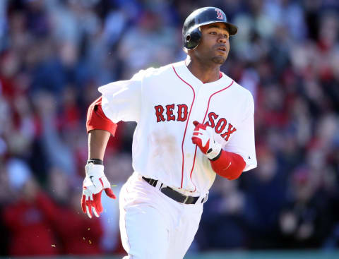 BOSTON, MA – MAY 01: Carl Crawford #13 of the Boston Red Sox heads for first while Jed Lowrie scores the game winning run in the bottom of the ninth inning against the Seattle Mariners on May 1, 2011 at Fenway Park in Boston, Massachusetts. The Boston Red Sox defeated the Seattle Mariners 3-2. (Photo by Elsa/Getty Images)