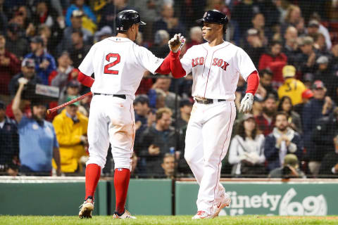 BOSTON, MA – JUNE 13: Rafael Devers #11 high fives Xander Bogaerts #2 of the Boston Red Sox after hitting a solo home run in the fifth inning of a game against the Texas Rangers at Fenway Park on June 13, 2019 in Boston, Massachusetts. (Photo by Adam Glanzman/Getty Images)