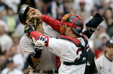 Boston Red Sox catcher Jason Varitek, right, strikes New York Yankees batter Alex Rodriguez at Fenway Park in Boston. The two fought after Rodriguez was hit by a pitch by Red Sox pitcher Bronson Arroyo. The Red Sox won, 11-10, with a 9th-inning game winning home run by Bill Mueller. (Photo by J Rogash/Getty Images)