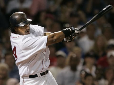 Boston Red Sox batter Manny Ramirez makes contact against the Texas Rangers, Saturday, July 10, 2004. Ramirez hit two home runs in the game. The Red Sox won 14-6 at Fenway Park in Boston. (Photo by J Rogash/Getty Images)