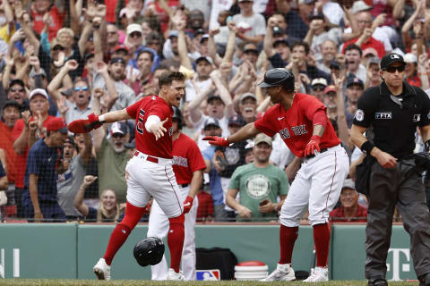 BOSTON, MA – JULY 25: Enrique Hernandez #5 of the Boston Red Sox is congratulated by Rafael Devers after scoring the go ahead run during the eighth inning of their 5-4 win over the New York Yankees at Fenway Park on July 25, 2021 in Boston, Massachusetts. (Photo By Winslow Townson/Getty Images)