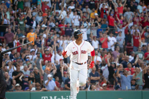 BOSTON, MA – AUGUST 14: Rafael Devers #11 of the Boston Red Sox slips his bat after hitting a home run against the Baltimore Orioles during the first inning at Fenway Park on August 14, 2021 in Boston, Massachusetts. (Photo by Rich Gagnon/Getty Images)