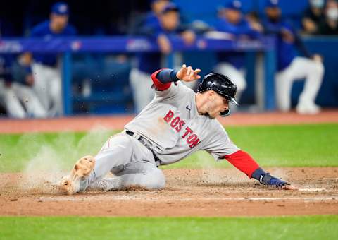 TORONTO, ON – APRIL 27: Trevor Story #10 of the Boston Red Sox slides safely into home base against the Toronto Blue Jays in the ninth inning during their MLB game at the Rogers Centre on April 27, 2022 in Toronto, Ontario, Canada. (Photo by Mark Blinch/Getty Images)