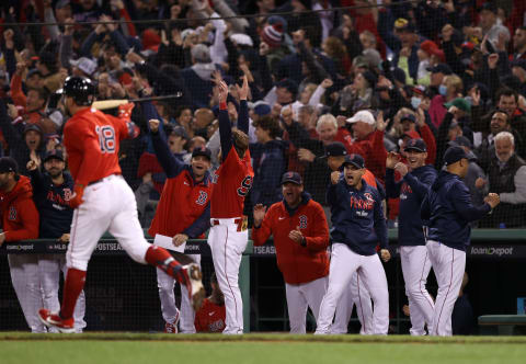 BOSTON, MASSACHUSETTS – OCTOBER 18: The Boston Red Sox dugout celebrate after Kyle Schwarber #18 of the Boston Red Sox hit a grand slam home run against the Houston Astros in the second inning of Game Three of the American League Championship Series at Fenway Park on October 18, 2021 in Boston, Massachusetts. (Photo by Elsa/Getty Images)