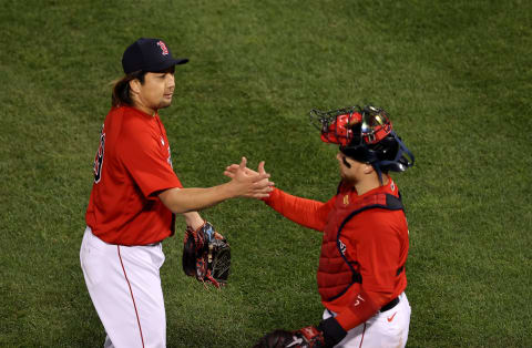 BOSTON, MASSACHUSETTS – OCTOBER 18: Hirokazu Sawamura#19 and Christian Vazquez #7 of the Boston Red Sox shake hands after they beat the Houston Astros in Game Three of the American League Championship Series at Fenway Park on October 18, 2021 in Boston, Massachusetts. (Photo by Omar Rawlings/Getty Images)