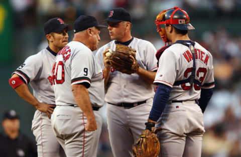 SEATTLE – AUGUST 13: Pitcher John Burkett #19 of the Boston Red Sox meets on the mound with shortstop Nomar Garciaparra #5, pitching coach Tony Cloninger and catcher Jason Varitek #33 during the MLB game against the Seattle Mariners on August 13, 2002 at Safeco Field in Seattle, Washington. The Mariners won 10-3. (Photo by Otto Greule Jr./Getty Images)