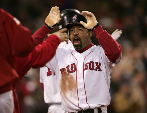 BOSTON – OCTOBER 18: Dave Roberts #31 of the Boston Red Sox celebrates with his teammates after scoring on a game tying sacrafice fly-out by teammate Jason Varitek #33 in the eighth inning against the New York Yankees during game five of the American League Championship Series on October 18, 2004 at Fenway Park in Boston, Massachusetts. (Photo by Doug Pensinger/Getty Images)