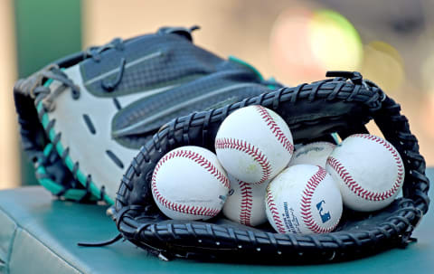 ANAHEIM, CA – AUGUST 16: Major league baseballs sit in a glove as the Seattle Mariners warm up before the game against the Los Angeles Angels at Angel Stadium of Anaheim on August 16, 2016 in Anaheim, California. (Photo by Jayne Kamin-Oncea/Getty Images)