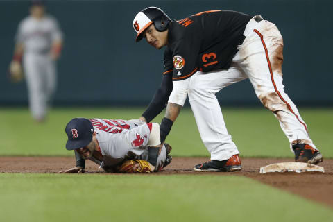 BALTIMORE, MD – APRIL 21: Dustin Pedroia #15 of the Boston Red Sox lays injured on the field after colliding at second base with Manny Machado #13 of the Baltimore Orioles in the eighth inning at Oriole Park at Camden Yards on April 21, 2017 in Baltimore, Maryland. (Photo by Matt Hazlett/Getty Images)