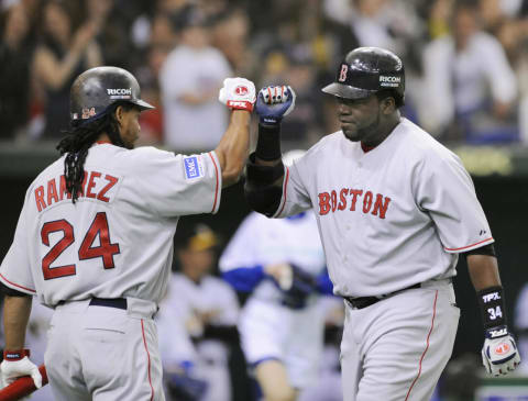 Boston Red Sox David Ortiz (R) is congratulated his solo homer by teammate Manny Ramirez in the top of the first innings against Japan’s Hanshin Tigers in an exhibition game in the Tokyo Dome on March 22, 2008. The Boston Red Sox managed a narrow 6-5 victory against Tigers in an exhibition game here, days ahead of the official season-opening games against the Oakland Athletics. AFP PHOTO / KAZUHIRO NOGI (Photo credit should read KAZUHIRO NOGI/AFP via Getty Images)