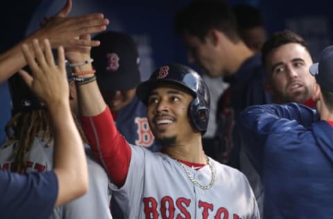 TORONTO, ON – JUNE 30: Mookie Betts #50 of the Boston Red Sox is congratulated by teammates in the dugout after scoring a run in the fifth inning during MLB game action against the Toronto Blue Jays at Rogers Centre on June 30, 2017 in Toronto, Canada. (Photo by Tom Szczerbowski/Getty Images)