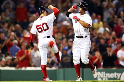 BOSTON, MA – MAY 17: Xander Bogaerts #2 bumps forearms with Mookie Betts #50 of the Boston Red Sox after hitting a three-run home run in the fifth inning of a game against the Baltimore Orioles at Fenway Park on May 17, 2018 in Boston, Massachusetts. (Photo by Adam Glanzman/Getty Images)