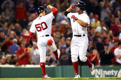 BOSTON, MA – MAY 17: Xander Bogaerts #2 bumps forearms with Mookie Betts #50 of the Boston Red Sox after hitting a three-run home run in the fifth inning of a game against the Baltimore Orioles at Fenway Park on May 17, 2018 in Boston, Massachusetts. (Photo by Adam Glanzman/Getty Images)