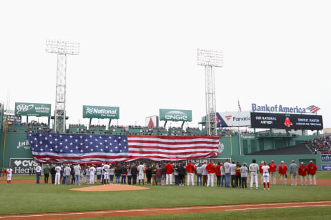 BOSTON, MA – MAY 28: The American Flag is draped from the Green Monster as Gold Star families and Veterans from the Red Sox organization look on before the game between the Boston Red Sox and the Toronto Blue Jays at Fenway Park on May 28, 2018 in Boston, Massachusetts. MLB Players across the league are wearing special uniforms to commemorate Memorial Day. (Photo by Omar Rawlings/Getty Images)