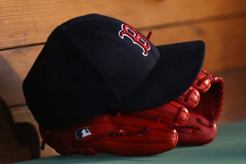 BOSTON, MA – June 6: A hat and glove sit in the Boston Red Sox dugout. (Photo by Maddie Meyer/Getty Images)