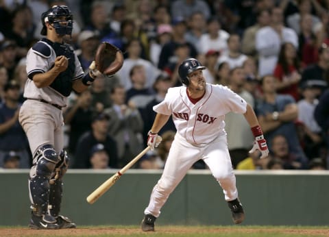 Boston Red Sox batter Bill Mueller, right, and New York Yankees catcher Jorge Posada watches Mueller ball leave the park for a home run at Fenway Park in Boston. The Red Sox won, 11-10, with a 9th-inning game winning home run by Bill Mueller. (Photo by J Rogash/Getty Images)