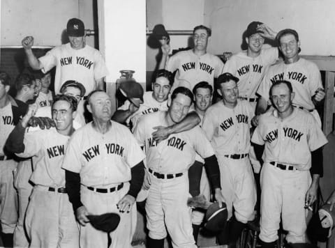 Members of the New York Yankees celebrate a victory over the Boston Red Sox at Fenway Park, Boston, Massachusetts, September 4, 1941. Players include, front row from left, Frenchy Bordagaray (1910 – 2001) (with arm raised), team manager Joe McCarthy (1887 – 1978), George Selkirk (1908 – 1987) (front row, center), and Phil Rizzuto (arm around Selkirk). (Photo by Hulton Archive/Getty Images)