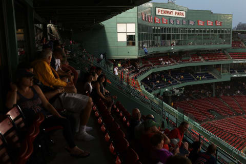 BOSTON, MA – AUGUST 2: Fans seek refuge from the storm during a rain delay at Fenway Park on August 2, 2017 in Boston, Massachusetts. (Photo by Maddie Meyer/Getty Images)