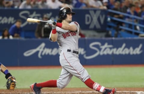 TORONTO, ON – AUGUST 29: Andrew Benintendi #16 of the Boston Red Sox hits a soft infield single in the sixth inning during MLB game action against the Toronto Blue Jays at Rogers Centre on August 29, 2017 in Toronto, Canada. (Photo by Tom Szczerbowski/Getty Images)