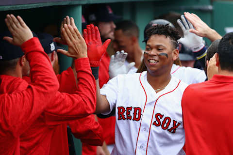 BOSTON, MA – OCTOBER 08: Rafael Devers #11 of the Boston Red Sox celebrates with teammates in the dugout after hitting a two-run home run in the third inning against the Houston Astros during game three of the American League Division Series at Fenway Park on October 8, 2017 in Boston, Massachusetts. (Photo by Maddie Meyer/Getty Images)