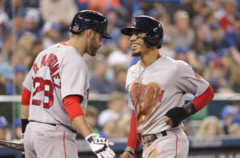 TORONTO, ON – MAY 12: Mookie Betts #50 of the Boston Red Sox is congratulated by J.D. Martinez #28 after scoring a run in the third inning during MLB game action against the Toronto Blue Jays at Rogers Centre on May 12, 2018 in Toronto, Canada. (Photo by Tom Szczerbowski/Getty Images)