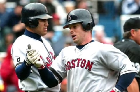 Boston Red Sox base runners Shea Hillenbrand (R) and Johnny Damon (L) congratulate each other after both scored on a single by Nomar Garciaparra in the third inning against the New York Yankees at Yankee Stadium in the Bronx, NY. The game was delayed by rain in the sixth inning. AFP PHOTO/Matt CAMPBELL (Photo by MATT CAMPBELL / AFP) (Photo credit should read MATT CAMPBELL/AFP via Getty Images)