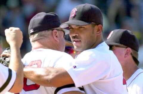 Closing pitcher Ugueth Urbina (R) of the Boston Red Sox celebrates after beating the Minnesota Twins 3-1 at Fenway Park 11 August 2002 in Boston, Massachusetts. AFP PHOTO/JOHN MOTTERN (Photo by JOHN MOTTERN / AFP) (Photo credit should read JOHN MOTTERN/AFP via Getty Images)