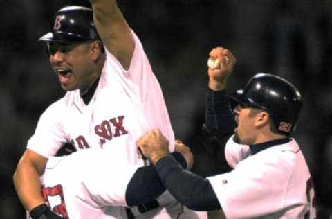 Carlos Baerga (L) of the Boston Red Sox celebrates hitting a sacrifice fly to win 9-8 over the New York Yankees in the 11th inning 24 May 2002 at Fenway Park in Boston Massachusetts. AFP PHOTO/JOHN MOTTERN (Photo by JOHN MOTTERN / AFP) (Photo by JOHN MOTTERN/AFP via Getty Images)