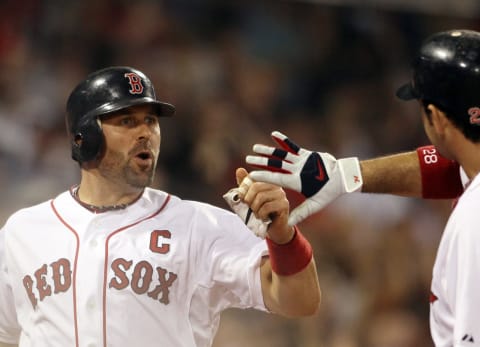 BOSTON, MA – AUGUST 31: Jason Varitek #33 of the Boston Red Sox is congratulated by Adrian Gonzalez #28 after Varitek scored in the sixth inning against the New York Yankees on August 31, 2011 at Fenway Park in Boston, Massachusetts. (Photo by Elsa/Getty Images)