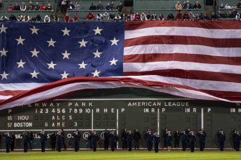 BOSTON, MA – OCTOBER 18: The American flag is dropped over the Green Monster before game three of the 2021 American League Championship Series between the Boston Red Sox and the Houston Astros at Fenway Park on October 18, 2021 in Boston, Massachusetts. (Photo by Billie Weiss/Boston Red Sox/Getty Images)