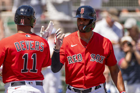 FT. MYERS, FL – MARCH 26: Rafael Devers #11 of the Boston Red Sox reacts with Xander Bogaerts #2 after hitting a solo home run during the first inning of a Grapefruit League game against the Tampa Bay Rays on March 26, 2022 at jetBlue Park at Fenway South in Fort Myers, Florida. (Photo by Billie Weiss/Boston Red Sox/Getty Images)