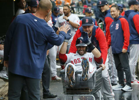 DETROIT, MI – April 11: J.D. Martinez #28 of the Boston Red Sox is pushed through the dugout in a laundry cart by Kevin Plawecki #25 after hitting a solo home run against the Detroit Tigers during the fifth inning at Comerica Park on April 11, 2022, in Detroit, Michigan. (Photo by Duane Burleson/Getty Images)