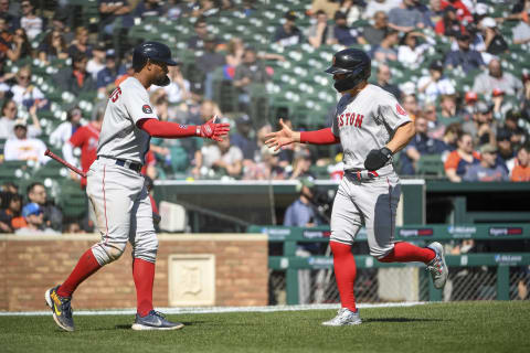 DETROIT, MICHIGAN – APRIL 12: Xander Bogaerts #2 of the Boston Red Sox high fives Enrique Hernandez #5 of the Boston Red Sox after Hernandez scored a run during the top of the eighth inning against the Detroit Tigers at Comerica Park on April 12, 2022 in Detroit, Michigan. (Photo by Nic Antaya/Getty Images)