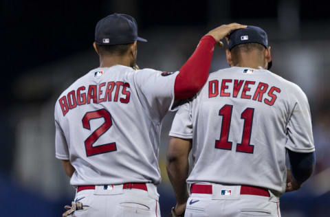 SOUTH WILLIAMSPORT, PENNSYLVANIA - AUGUST 21: Xander Bogaerts #2 of the Boston Red Sox reacts with Rafael Devers #11 of the Boston Red Sox during the third inning of the 2022 Little League Classic game against the Baltimore Orioles on August 21, 2022 at Bowman Field on August 21, 2022 in South Williamsport, Pennsylvania/ (Photo by Maddie Malhotra/Boston Red Sox/Getty Images)