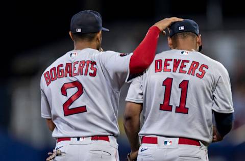 SOUTH WILLIAMSPORT, PENNSYLVANIA - AUGUST 21: Xander Bogaerts #2 of the Boston Red Sox reacts with Rafael Devers #11 of the Boston Red Sox during the third inning of the 2022 Little League Classic game against the Baltimore Orioles on August 21, 2022 at Bowman Field on August 21, 2022 in South Williamsport, Pennsylvania/ (Photo by Maddie Malhotra/Boston Red Sox/Getty Images)