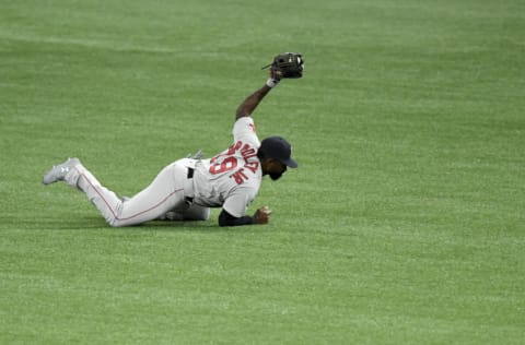 ST PETERSBURG, FLORIDA - AUGUST 04: Jackie Bradley Jr. #19 of the Boston Red Sox makes a diving catch on a hit from Brandon Lowe #8 of the Tampa Bay Rays (not pictured) to end the third inning at Tropicana Field on August 04, 2020 in St Petersburg, Florida. (Photo by Douglas P. DeFelice/Getty Images)