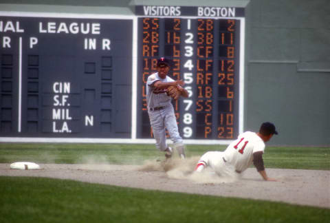 BOSTON, MA – CIRCA 1965: Zoilo Versalles #2 of the Minnesota Twins completes the double-play throwing over the top of Frank Malzone #11 of the Boston Red Sox during an Major League baseball game circa 1965 at Fenway Park in Boston, Massachusetts. Boggs played for the Washington Senators/Twins from 1959-67. (Photo by Focus on Sport/Getty Images)